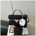 Fashionable black crossbody bag with pleated cover, gold hardware and plush charm - Black (With Charm)