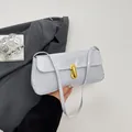 Chic light gray glossy leather shoulder bag with a vintage gold metal U-shaped lock - White