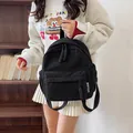 Small black corduroy backpack for women with fashion label and textured casual style - Black