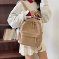 Fashionable khaki corduroy mini backpack with woven zippers shown on a model - Khaki