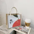 Minimalist canvas tote with jute trim and orange fruit print for daily use - Orange