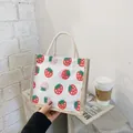 White canvas tote bag with strawberry prints and thick cotton rope handles - Strawberry