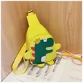Detail of yellow kids dinosaur chest bag with adjustable strap on a wooden surface - Yellow