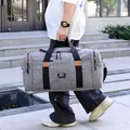 Grey large capacity travel duffel bag with black straps and brown leather accents - Gray