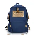 Donkerblauwe canvas rugzak met bruin lederen details en groot logo-embleem erop - Blauw