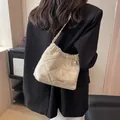 Elegant beige quilted chain bucket bag with drawstring detail and gold hardware - Off-white