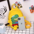 Mini yellow dinosaur canvas bag for kids shown next to a phone for size reference - Yellow