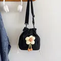 Mini black canvas drawstring bucket bag with a cute plush flower pendant and adjustable strap - Black