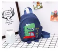 Close-up of navy blue toddler backpack with dinosaur cartoon and adjustable straps - Blue