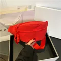 Stylish red nylon chest bag for women with woven zipper puller and adjustable strap - Red