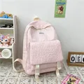 Pink bubble textured backpack with front buckle straps and minimalist student design - Pink