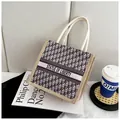 Retro woven tote bag with Liberty text and woven handles shown from a 45-degree angle - Vintage Monogram (Style 1)