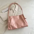 Light pink PU leather tote bag with embossed lettering and stylish knot handle details - Pink