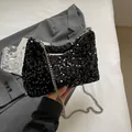 Fashionable black sequin hobo bag with silver chain strap on a stylish grey blazer - Black