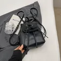 Elegant black leather backpack with bow detail and adjustable straps on blazer backdrop - Black