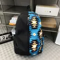 Student backpack featuring a unique black and blue geometric ethnic totem print design - Blue