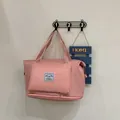Light pink foldable travel tote with expandable bottom and front storage pocket - Pink