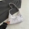 Witte hobo-tas met zilveren vlinderprint en verstelbare schouderband in strak design - Zilver