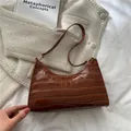 Brown crocodile embossed underarm bag with glossy finish and vintage semi-circle design - Light Brown