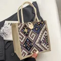 Ethnic canvas tote bag featuring geometric embroidery and natural wooden button closure - Button Decor Style / Black