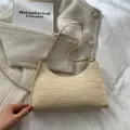 Creamy white crocodile pattern underarm shoulder bag with minimalist curved design - Beige