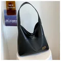 Classic black PU leather tote bag with front pocket and elegant metallic logo detail - Black