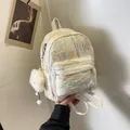 White mini backpack with colorful wave embroidery and cute cloud charm held by hand - White