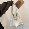 Minimalist off-white oversized hobo shoulder bag in textured PU leather with front pocket - White