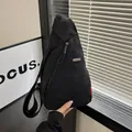 Black waterproof nylon crossbody chest bag with adjustable strap and metal logo - Black