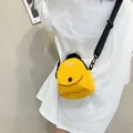 Minimalist bright yellow canvas crossbody bag with adjustable black strap shown on model - Yellow