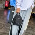 Minimalist black canvas crossbody bag with KǑQ logo for women, casual urban style - Black