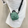 Minimalist mint green canvas crossbody phone bag with adjustable strap and logo detail - Green