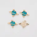 Macro detail of alloy planet charms showing blue enamel stars and golden metal texture - Sky Blue