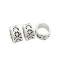 Macro view of vintage silver alloy star and moon charm beads with celestial patterns - Antique Silver