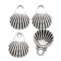 Detail view of four vintage silver shell pendants in zinc alloy with radial stripes - Antique Silver