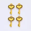 Detailed view of four golden vintage crown key charms for DIY jewelry accessories - Antique Gold