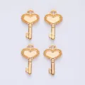 Close-up of four vintage gold heart key charms for DIY jewelry making and crafting - KC Gold