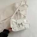 White faux leather underarm bag featuring woven bow design and silver metal clasp - White