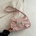 Pink PU leather shoulder bag with large bow design and silver metal butterfly clasp - Pink