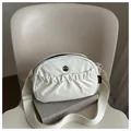 Creamy crescent nylon crossbody bag with pleated pockets and adjustable strap - White