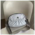 Beige nylon crossbody bag with pleated texture and adjustable wide shoulder strap - Gray