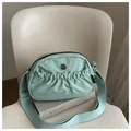 Large mint green nylon crossbody bag with adjustable strap and metallic M logo - Green