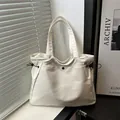 Off-white nylon tote bag with black drawstring details and zipper closure in a bright setting - No Pendant / White