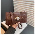 Chic dark brown leather shoulder bag with stylish silver metal lock and thin strap - Brown