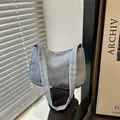 Light blue denim hobo bag featuring colorful bow prints and an integrated shoulder strap - Light Blue