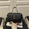 Schwarze Umhängetasche mit Litschimuster, Goldschnalle und elegantem Tragegriff - Schwarz