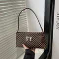 Brown vintage polka dot pattern underarm bag with a stylish silver metal bow buckle - Monogram Coffee