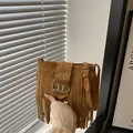 Brown frosted suede crossbody bag with long tassels and large metal buckle detail - Dark Brown