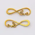 Detailed view of golden infinity LOVE connector charms for DIY jewelry making - Antique Gold