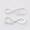 Macro detail of silver vintage infinity LOVE pendants for DIY jewelry making - Bright Silver